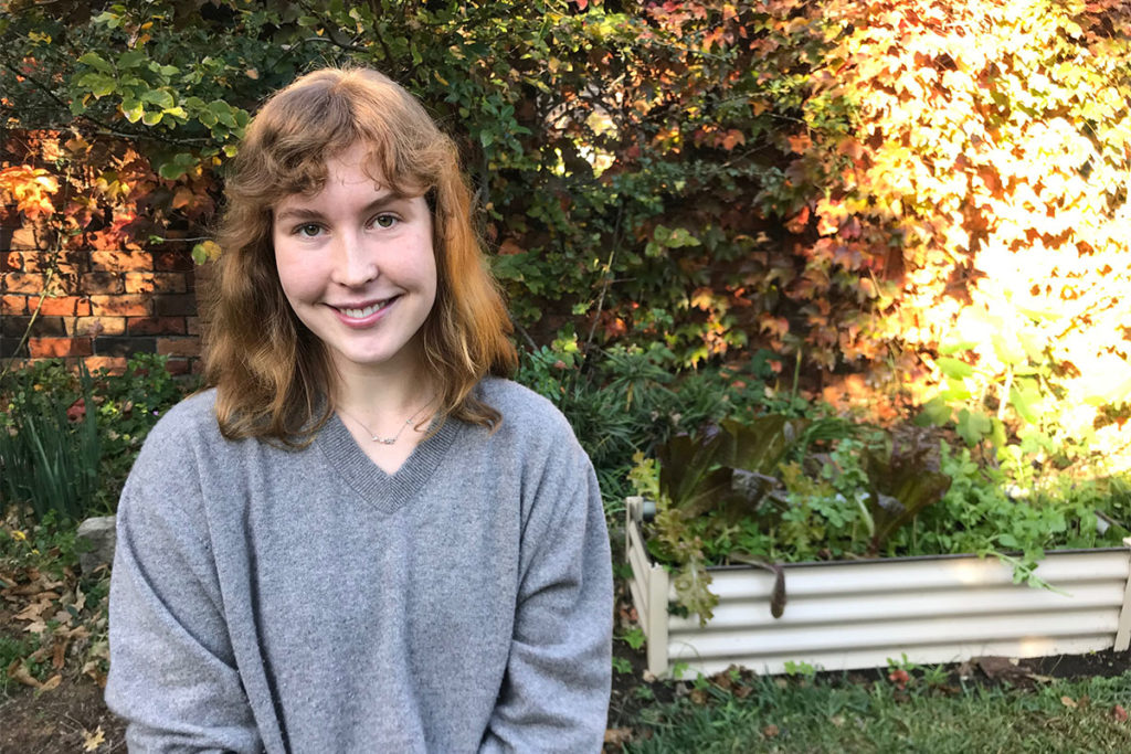 Anna standing in front of a tree